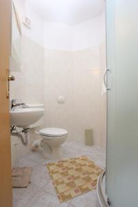 a bathroom with a toilet and a sink at Apartments by the sea Slatine, Ciovo - 14541 in Slatine +51 photos