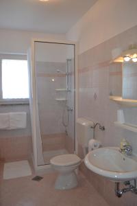 a bathroom with a shower and a toilet and a sink at Apartments for families with children Zambratija, Umag - 14557 in Savudrija