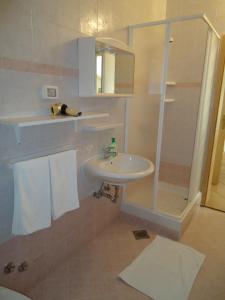 a bathroom with a sink and a shower with towels at Apartments for families with children Zambratija, Umag - 14557 in Savudrija