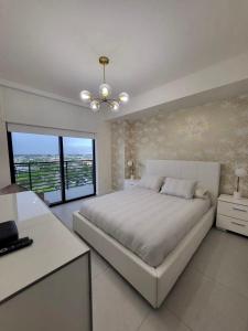 a white bedroom with a large bed and a window at DOWNTOWN DORAL, FLORIDA. NEW CONDO STYLE RESORT. in Miami +32 photos