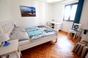 a small bedroom with a bed and a desk at Holiday house with a parking space Seline, Paklenica - 16318 in Starigrad