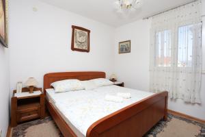 a bedroom with a bed with two towels on it at Apartments by the sea Slatine, Ciovo - 16341 in Slatine