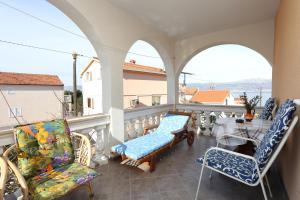 a balcony with chairs and a table with a view at Apartments by the sea Slatine, Ciovo - 16341 in Slatine