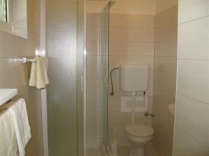 a bathroom with a toilet and a glass shower at Apartments with parking space Palit, Rab - 16356 in Mundanije +25 photos