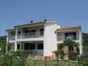 a large white house with a balcony at Apartment Palit 16356b in Mundanije