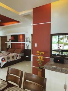 a bedroom with a bed and a television in it at Beach getaway Studio Villa in Lobo in Lobo