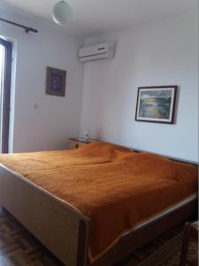 a bedroom with a large bed in a room at Apartments with parking space Banjol, Rab - 16334 in Rab