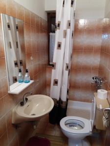a bathroom with a toilet and a sink at Apartments with parking space Banjol, Rab - 16334 in Rab +15 photos