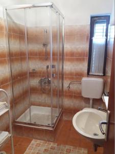 a bathroom with a shower and a toilet and a sink at Apartments with parking space Banjol, Rab - 16334 in Rab