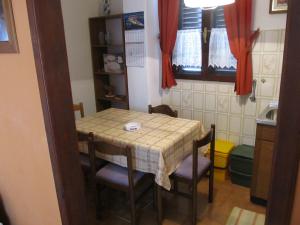 a small kitchen with a table and chairs in a room at Apartments with parking space Banjol, Rab - 16334 in Rab