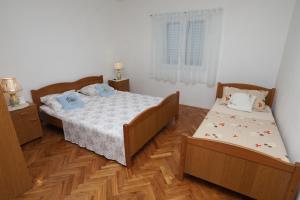 Postel nebo postele na pokoji v ubytování Apartment Vinisce 16439b