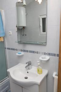 a bathroom with a sink and a mirror at Apartment Vinisce 16439b in Vinišće