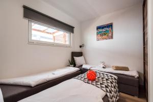 a room with two beds and a window at Apartments with WiFi Pirovac, Sibenik - 16443 in Pirovac