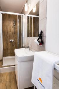 a white bathroom with a sink and a shower at Apartments with WiFi Pirovac, Sibenik - 16443 in Pirovac