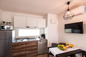 a kitchen with a table with a bowl of fruit on it at Apartments with WiFi Pirovac, Sibenik - 16443 in Pirovac