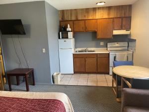 a small kitchen with a white refrigerator and a table at Wye Motel in Clinton