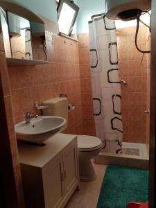 a bathroom with a sink and a toilet and a shower at Apartments with a parking space Tar, Porec - 16475 in Tar