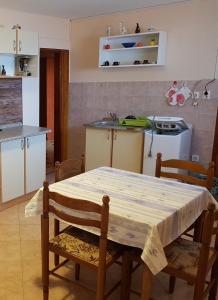 a kitchen with a table with a table cloth on it at Apartments with a parking space Tar, Porec - 16475 in Tar