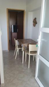 a dining room with a table and chairs and a refrigerator at Apartments with parking space Kolan, Pag - 16482 in Kolan +5 photos
