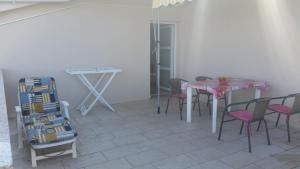 a dining room with a pink table and chairs at Apartments with parking space Kolan, Pag - 16482 in Kolan