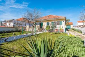 a house with a garden in front of it at Holiday house with a parking space Vrsi - Mulo, Zadar - 16527 in Vrsi