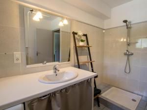 a bathroom with a sink and a mirror and a shower at Gîte chaleureux à Daglan avec terrasse et parking - FR-1-616-275 in Daglan +9 photos