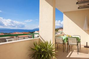 a patio with a table and chairs on a balcony at Apartments with a parking space Tucepi, Makarska - 14457 in Tučepi