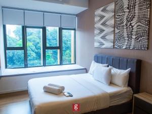 a bedroom with a bed with a large window at Ceylonz KLCC by Gsuites in Kuala Lumpur