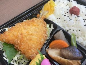 a plastic container of food with rice and vegetables at Hotel Kudou Oita in Oita