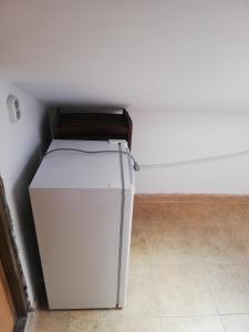 a small refrigerator in a corner of a room at Guest Room Asparuh in Troyan