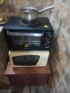 a toaster oven with a pot on top of it at Guest Room Asparuh in Troyan