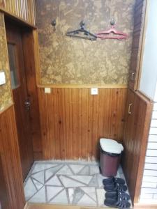 a bathroom with a toilet and a trash can at Guest Room Asparuh in Troyan
