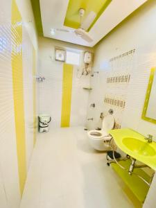 a bathroom with a yellow sink and a toilet at JAWAHAR VILLA - 2BHK - City Centre in Jodhpur