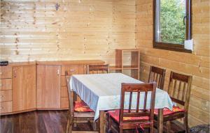 a dining room with a table and chairs in a room at 2 Bedroom Cozy Home In Leba-nowecin in Łeba