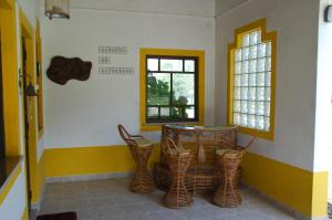 a room with chairs and a table and a window at Quinta A Reforma in Rossio ao Sul do Tejo