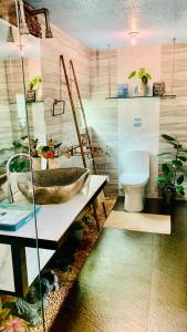 a bathroom with a sink and a toilet at Hidden of Cailan Inn in El Nido