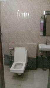 a bathroom with a white toilet and a sink at Hotel Vanya Palace By WB Inn in Agra