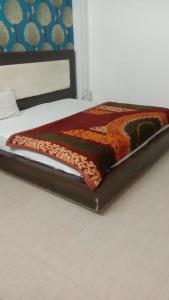 a close up of a bed with a blanket on it at Hotel Vanya Palace By WB Inn in Agra