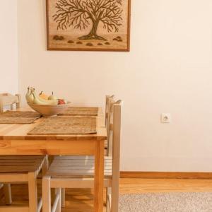 a dining room table with a bowl of fruit on it at Nasos Corfu Town Apartment in Corfu