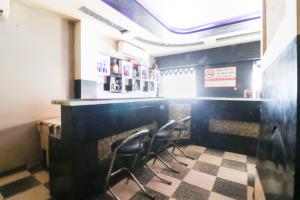 a bar with four chairs in a restaurant at Hotel Natraj in Bilāspur