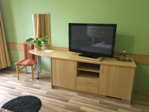 TV en un soporte de madera en una habitación en A Bárány en Kaposvár
