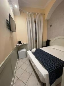 a hotel room with a bed and a tv at Casa di Stefano in Rome