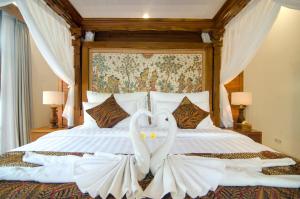 Postel nebo postele na pokoji v ubytování Danakha Villa Ubud