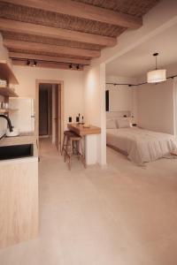 a kitchen and a bedroom with a bed and a table at Om Living Afitos in Afitos