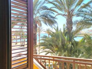 a view from the balcony of a resort with palm trees at Puesta De Sol Residence in Lampedusa