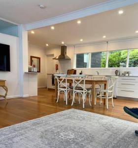 a kitchen and dining room with a table and chairs at Large Kingston Beach Home Setup For Comfort in Kingston Beach