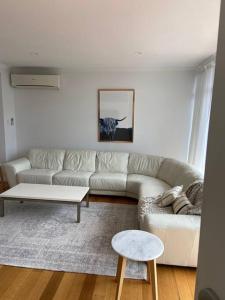 a living room with a couch and a coffee table at Large Kingston Beach Home Setup For Comfort in Kingston Beach