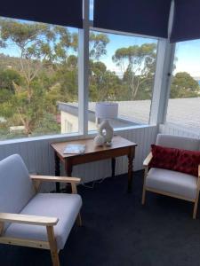 a room with a table and two chairs and a table and a window at Large Kingston Beach Home Setup For Comfort in Kingston Beach