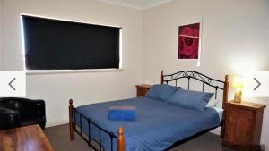 Ένα ή περισσότερα κρεβάτια σε δωμάτιο στο The Ningaloo breeze villa 4
