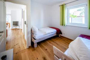 a room with two beds and a window and a couch at Chalet Altalmrich in Naumburg